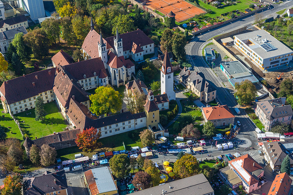 View of Göss collegiate church and the Kirtag fair