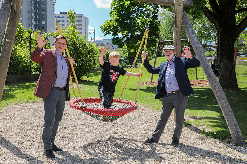 Bürgermeister Wallner und Referatsleiter Kieninger am Spielplatz mit einem kleinen Jungen