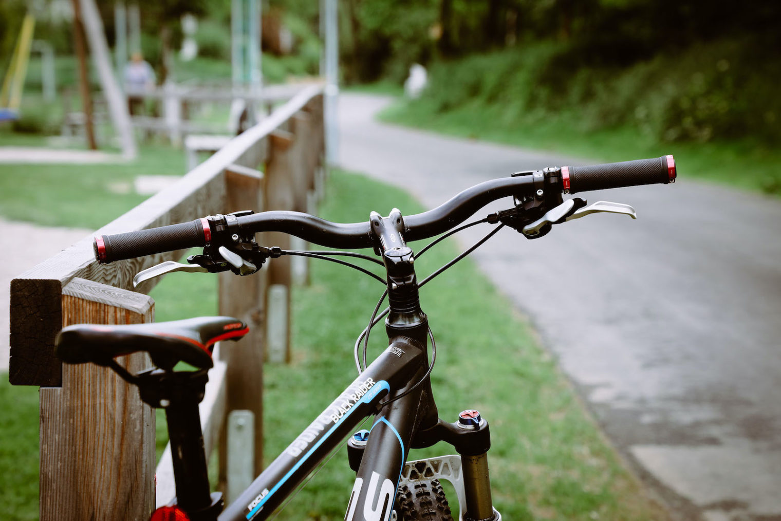 Schwarzes Fahrrad an Zaun gelehnt